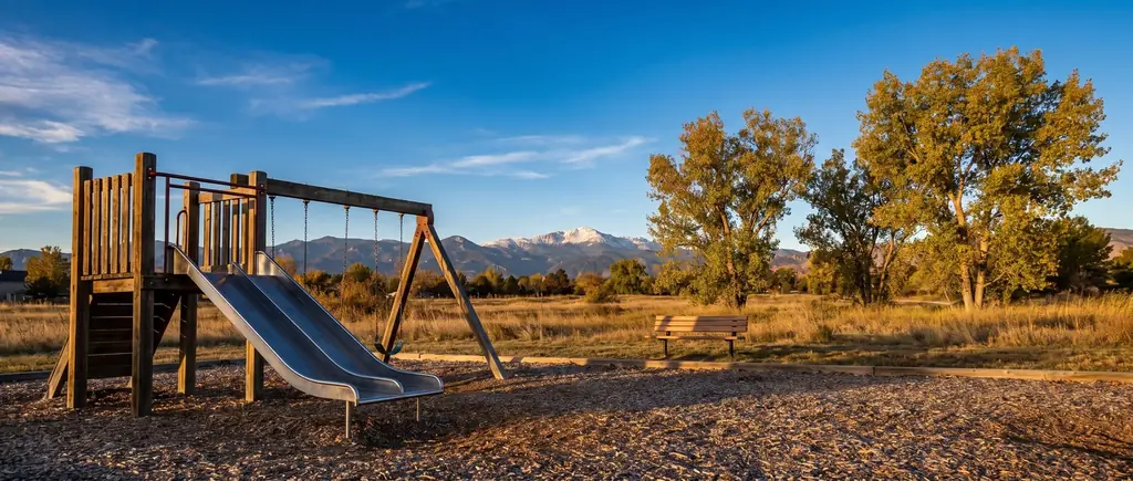 A neighbourhood playground in a Colorado suburb at golden hour