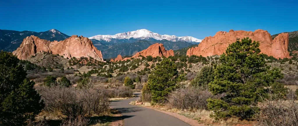 Red sandstone fins at Garden of the Gods with Pikes Peak behind